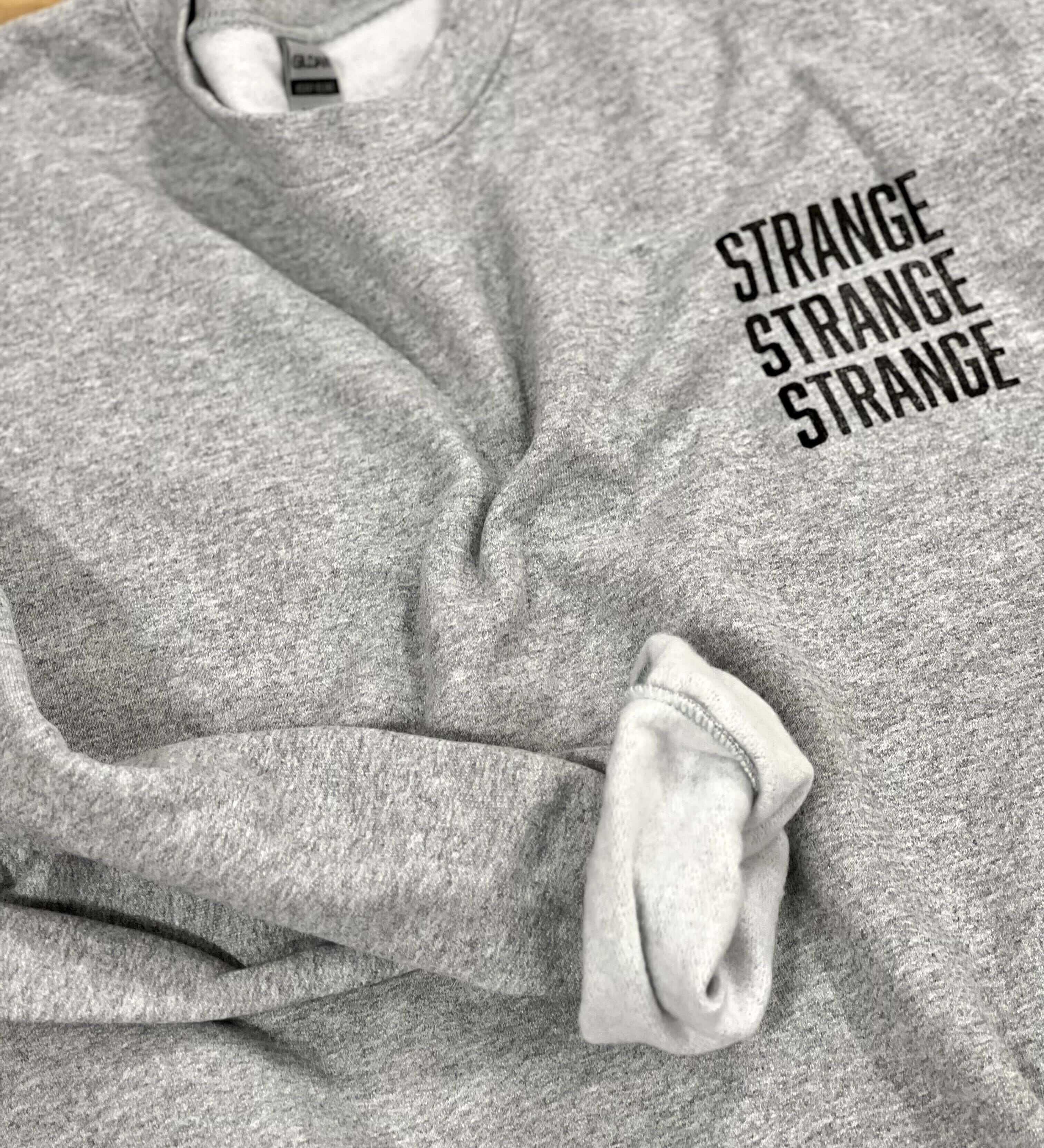 "Strange Strange Strange" small logo crewnecks