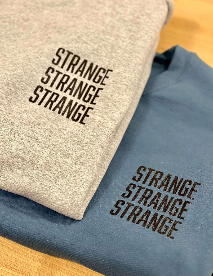 "Strange Strange Strange" small logo crewnecks
